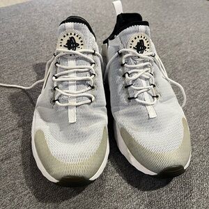 White and Black women’s Nike Huarache shoes